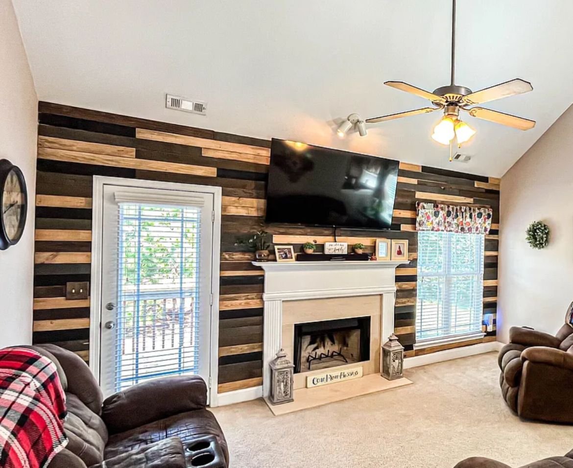 Custom reclaimed wood accent wall with fireplace and TV mount