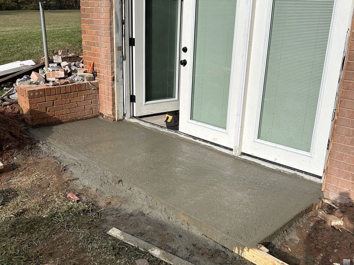 Fresh concrete porch pad installation
