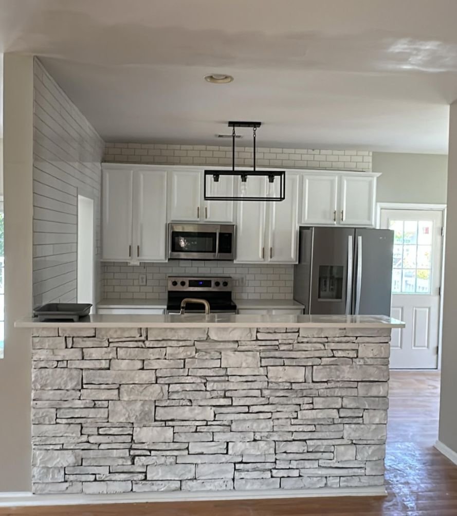 Kitchen remodel with stone island and subway tile backsplash
